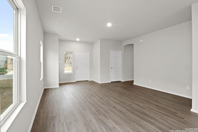 9410 Graze Land, San Antonio, TX 78211 - unfurnished living room with arched walkways, baseboards, wood finished floors, and recessed lighting