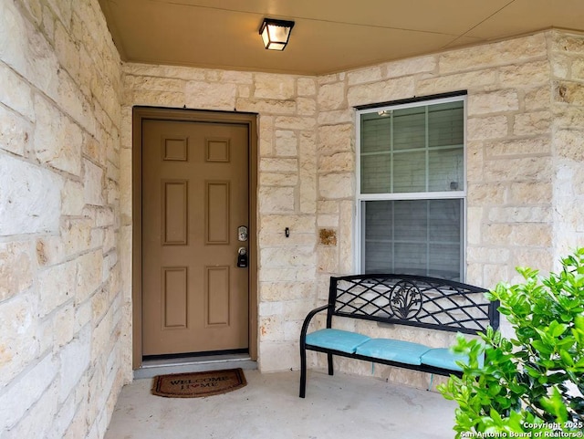 entrance to property with stone siding