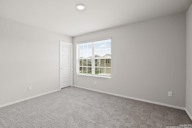 carpeted spare room with baseboards