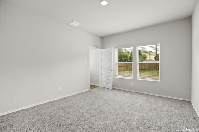 unfurnished room with baseboards and carpet floors