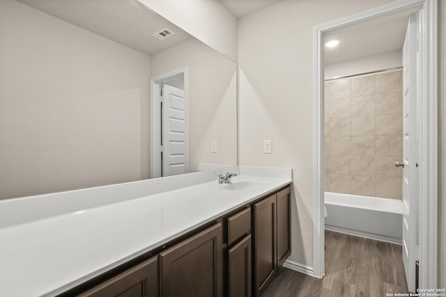 9318 Graze Land Dr, San Antonio, TX 78211 - full bathroom featuring wood finished floors, vanity, toilet, and shower / bath combination