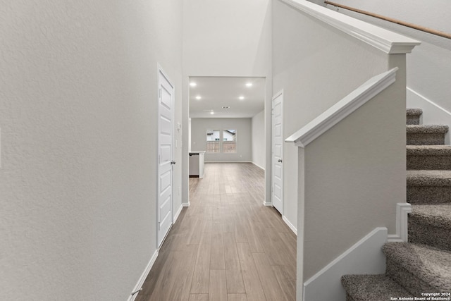 9322 Graze Br, San Antonio, TX 78211 - corridor featuring wood finished floors, stairway, recessed lighting, and baseboards