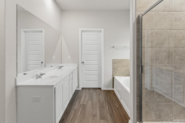 9322 Graze Br, San Antonio, TX 78211 - bathroom featuring wood finished floors, a shower stall, a bath, and double vanity