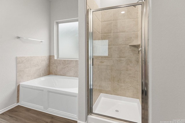 9322 Graze Br, San Antonio, TX 78211 - bathroom with a shower stall, a bath, and wood finished floors
