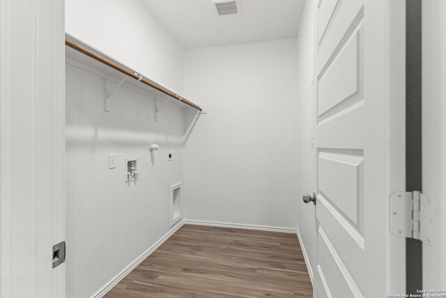 9322 Graze Br, San Antonio, TX 78211 - clothes washing area with hookup for a gas dryer, washer hookup, wood finished floors, and baseboards