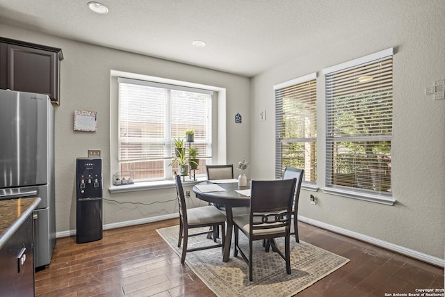 11734 Violet Cv, San Antonio, TX 78253 - dining area with dark wood-style flooring, baseboards, and a textured wall
