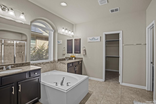 11734 Violet Cv, San Antonio, TX 78253 - full bath with a shower stall, two vanities, a garden tub, tile patterned flooring, and a walk in closet