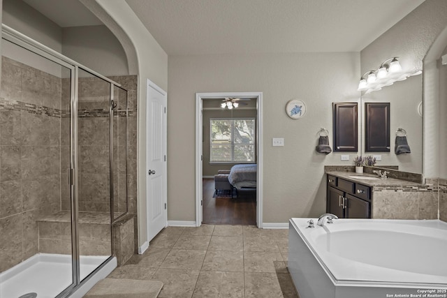 11734 Violet Cv, San Antonio, TX 78253 - bathroom featuring a stall shower, a bath, vanity, baseboards, and a ceiling fan