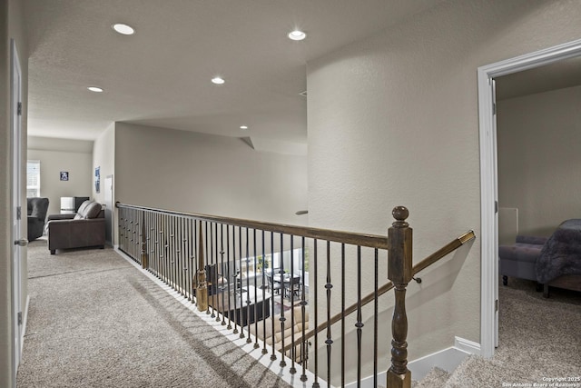 11734 Violet Cv, San Antonio, TX 78253 - hall with carpet, recessed lighting, baseboards, a textured wall, and an upstairs landing