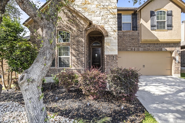 11734 Violet Cv, San Antonio, TX 78253 - view of front of house with a garage, brick siding, concrete driveway, and stone siding