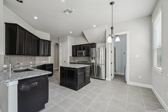 11526 Lily Blair, San Antonio, TX 78253 - kitchen featuring stainless steel appliances, a sink, arched walkways, backsplash, and dark cabinets