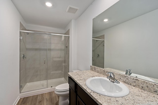 10827 Quinn Ct, San Antonio, TX 78252 - bathroom with toilet, a stall shower, wood finished floors, vanity, and recessed lighting