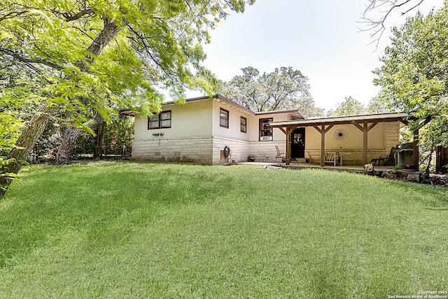 2027 Edgehill Dr, San Antonio, TX 78209 - rear view of property with stucco siding, a yard, a patio area, and stone siding