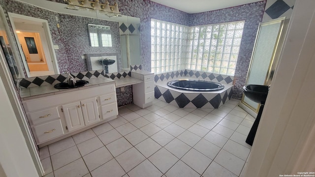 7 Glen Cove Dr, Seguin, TX 78155 - bathroom featuring tile patterned floors, a garden tub, vanity, and decorative backsplash