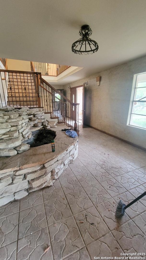 7 Glen Cove Dr, Seguin, TX 78155 - empty room with plenty of natural light and stairway