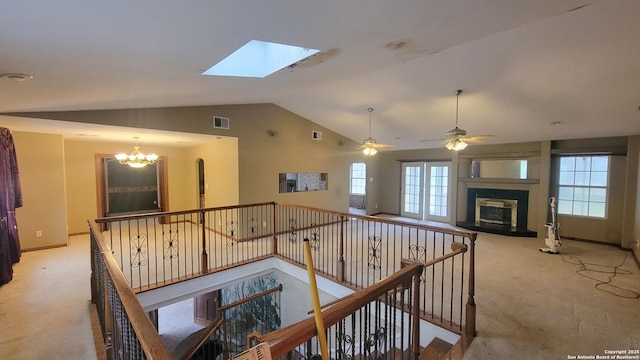 7 Glen Cove Dr, Seguin, TX 78155 - hallway featuring vaulted ceiling, a chandelier, an upstairs landing, light carpet, and a skylight