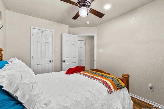 bedroom with wood finished floors, baseboards, and ceiling fan