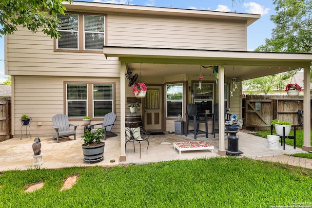 back of property with a patio and a gate