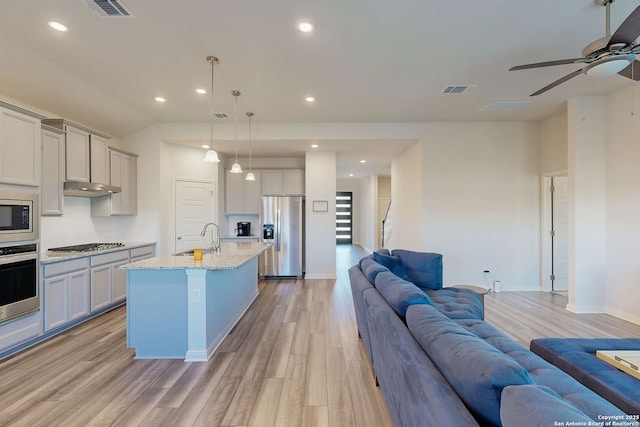 10259 Juniper Oaks, Boerne, TX 78006 - kitchen featuring stainless steel appliances, open floor plan, a sink, a ceiling fan, and light wood finished floors