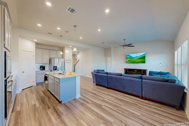 10259 Juniper Oaks, Boerne, TX 78006 - kitchen with stainless steel appliances, open floor plan, light wood-style flooring, a sink, and recessed lighting