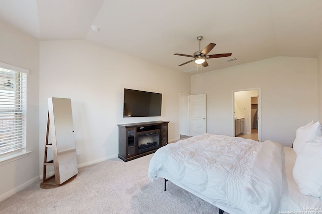 10259 Juniper Oaks, Boerne, TX 78006 - bedroom with vaulted ceiling, light carpet, a glass covered fireplace, a ceiling fan, and baseboards