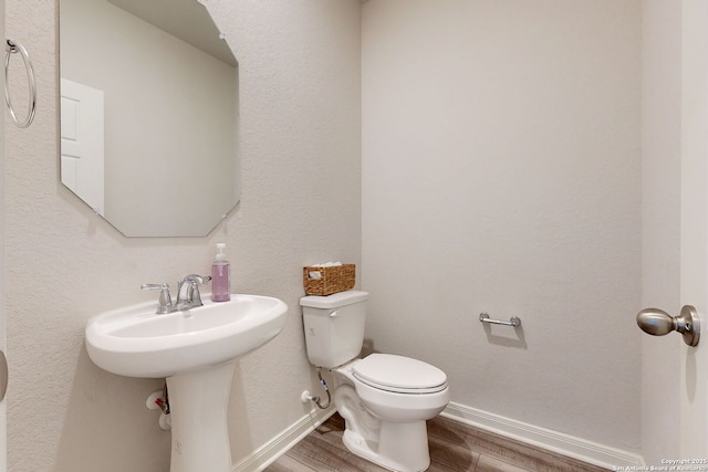 10259 Juniper Oaks, Boerne, TX 78006 - half bathroom featuring wood finished floors, toilet, and baseboards