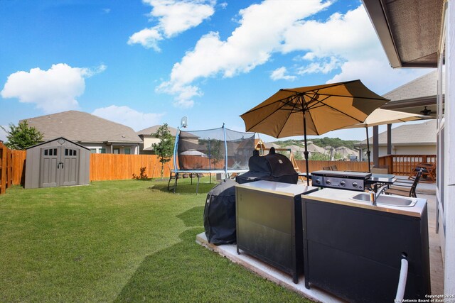 10259 Juniper Oaks, Boerne, TX 78006 - view of yard with a trampoline, a storage shed, a sink, and an outdoor structure