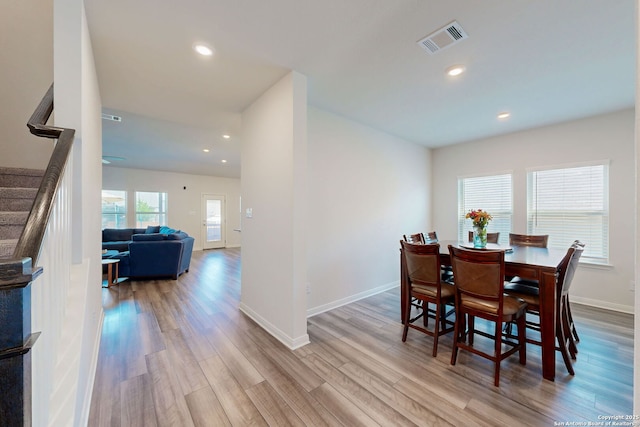10259 Juniper Oaks, Boerne, TX 78006 - dining room with wood finished floors, stairs, baseboards, and recessed lighting