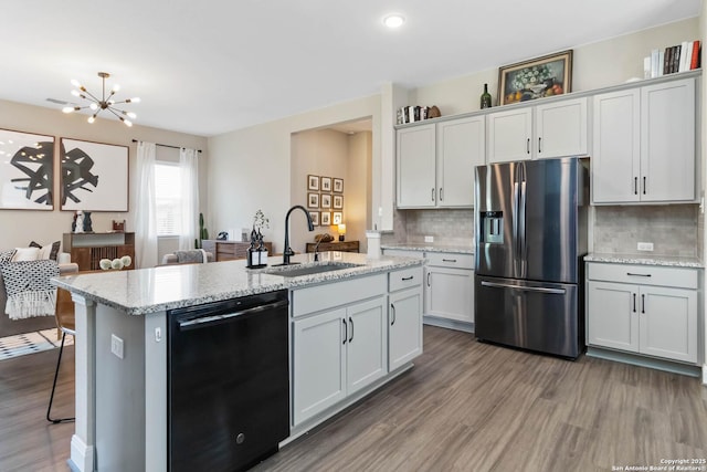612 Wipper, New Braunfels, TX 78130 - kitchen featuring stainless steel fridge with ice dispenser, dishwasher, a sink, wood finished floors, and a kitchen island with sink