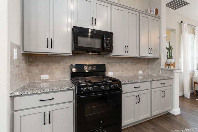 612 Wipper, New Braunfels, TX 78130 - kitchen featuring black appliances, wood finished floors, light stone countertops, and decorative backsplash