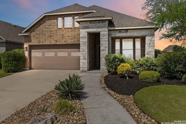 612 Wipper, New Braunfels, TX 78130 - view of front facade with stone siding, concrete driveway, brick siding, a shingled roof, and a garage