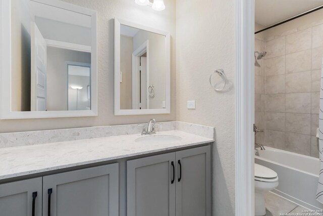 612 Wipper, New Braunfels, TX 78130 - full bath with vanity, toilet, shower / bath combination with curtain, tile patterned floors, and a textured wall