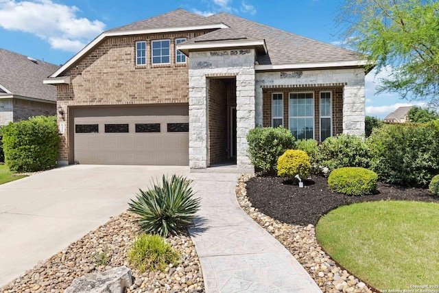 612 Wipper, New Braunfels, TX 78130 - view of front of house with concrete driveway, stone siding, roof with shingles, brick siding, and an attached garage