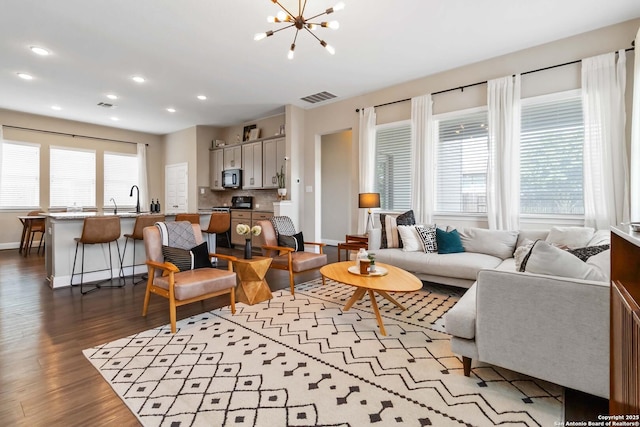 612 Wipper, New Braunfels, TX 78130 - living room featuring dark wood-style flooring, baseboards, recessed lighting, and a chandelier