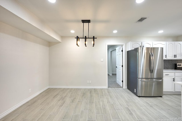5914 Pineway, San Antonio, TX 78247 - kitchen featuring freestanding refrigerator, white cabinetry, recessed lighting, baseboards, and light wood-style floors