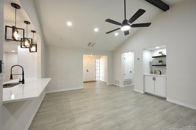 5914 Pineway, San Antonio, TX 78247 - unfurnished living room with a sink, high vaulted ceiling, a ceiling fan, beamed ceiling, and recessed lighting