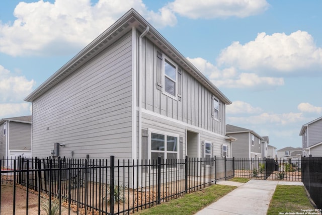 10819 Quinn Ct, San Antonio, TX 78252 - view of home's exterior featuring board and batten siding, fence, and a residential view