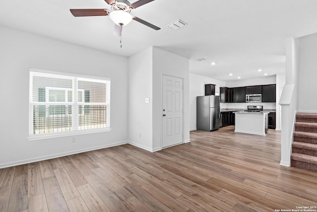 10819 Quinn Ct, San Antonio, TX 78252 - unfurnished living room with stairway, light wood finished floors, ceiling fan, recessed lighting, and baseboards