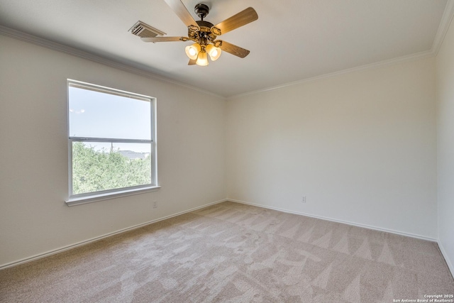 empty room with light carpet, ornamental molding, a ceiling fan, and baseboards
