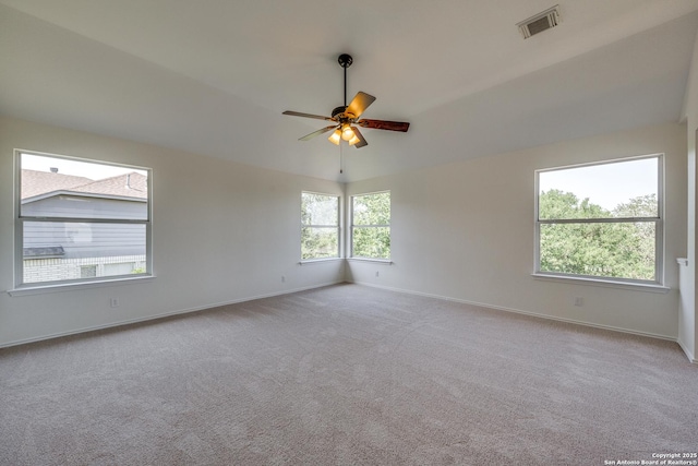carpeted spare room with baseboards and a ceiling fan