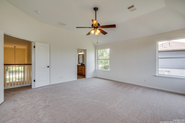 carpeted spare room with a ceiling fan, baseboards, vaulted ceiling, and a smoke detector