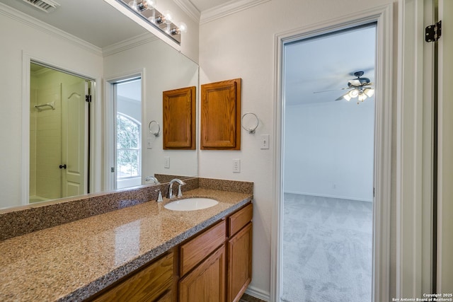 full bath featuring ornamental molding, vanity, a shower, ceiling fan, and baseboards