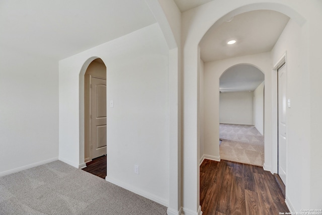 11920 Stroud Dr, San Antonio, TX 78252 - hall with dark colored carpet, arched walkways, and baseboards