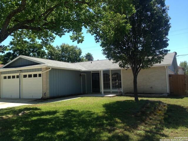 single story home with a garage, board and batten siding, brick siding, and driveway