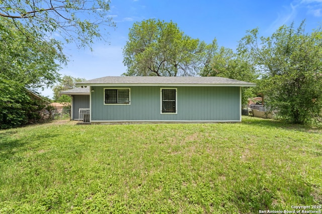 rear view of house featuring a yard