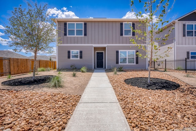 10825 Quinn Ct, San Antonio, TX 78252 - traditional-style home with board and batten siding and a fenced backyard