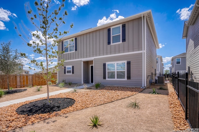 10825 Quinn Ct, San Antonio, TX 78252 - traditional-style home with board and batten siding, central air condition unit, a fenced backyard, and a patio