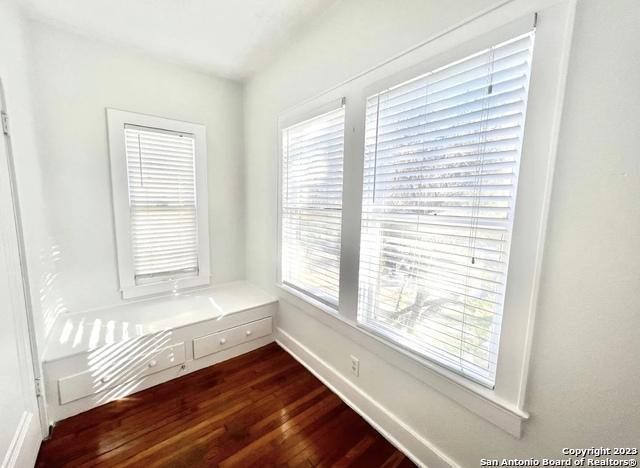interior space featuring dark wood-type flooring and baseboards