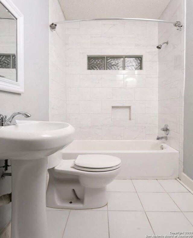 bathroom with tile patterned floors, tub / shower combination, and toilet