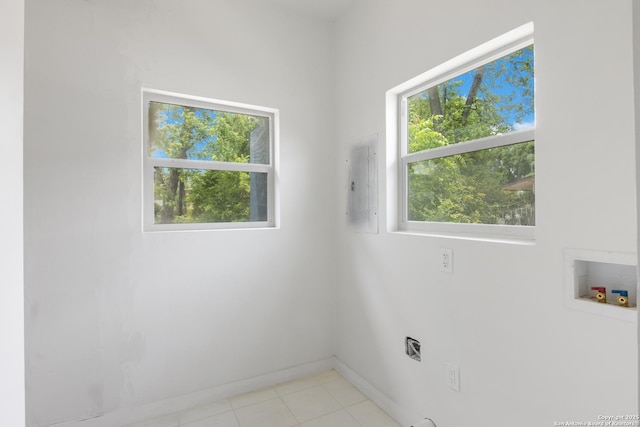 1144 Denver, San Antonio, TX 78210 - washroom with electric panel, hookup for a washing machine, baseboards, and light tile patterned floors